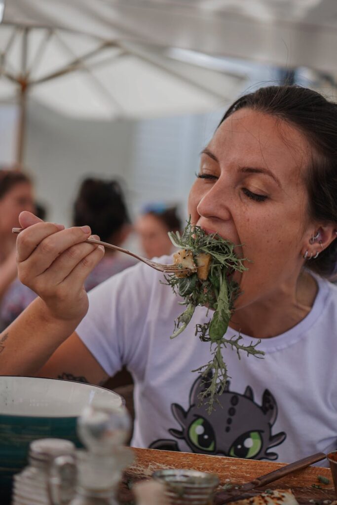 photo of a woman eating a salad
