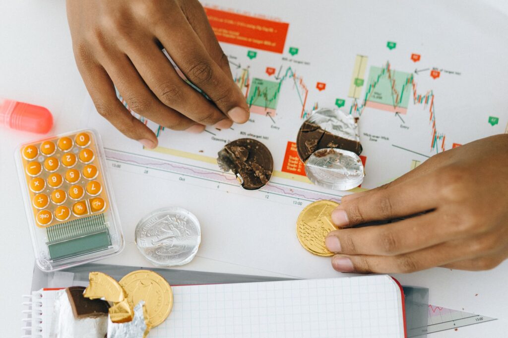 person holding chocolate coins on white paper